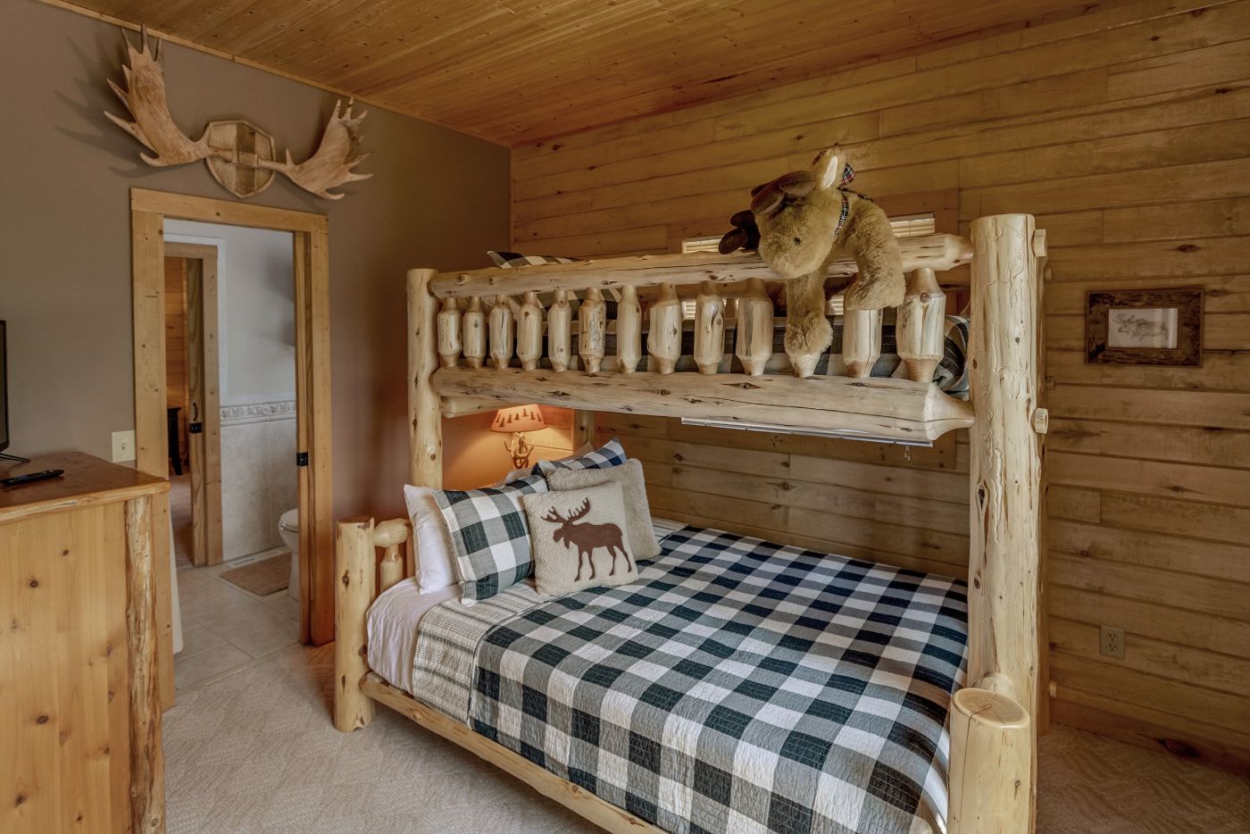 Bunk room with twin-over-queen log bunk